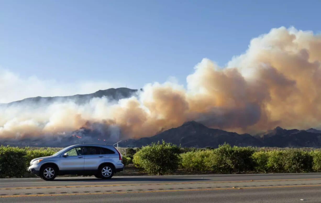 The Mountain Fire burns on a hillside in Santa Paula on Nov. 7. (Myung J.