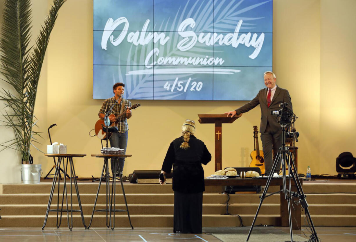 At the Godspeak Calvary Chapel in Newbury Park, Calif., Senior Pastor Rob McCoy, right, presides over a service during the COVID-19 pandemic.