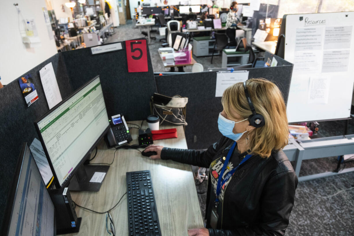 Crisis Line phone workers take calls at Crisis Connections on April 8, 2022.