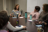 Clinical supervisor Brook Vejo, center, talks with the Youth Mobile Crisis Intervention team during a December 2019 meeting at Catholic Community Services in Vancouver.