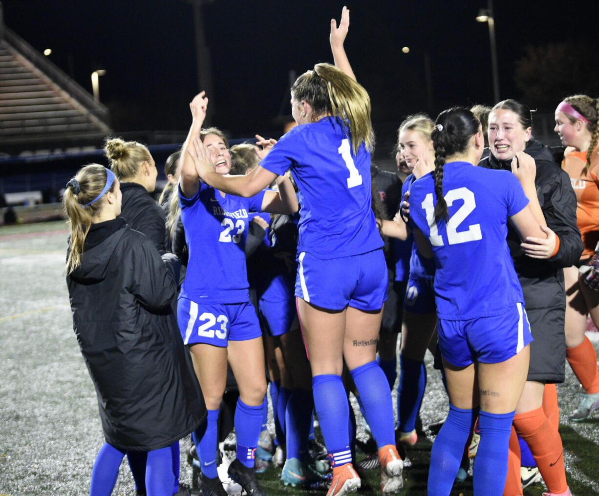 Ridgefield's Abigail Vance (23) and Nora Martin (1) jump in jubilation after defeating Columbia River 1-0 in the championship game on Saturday, Nov. 23, 2024, at Mount Tahoma High School.