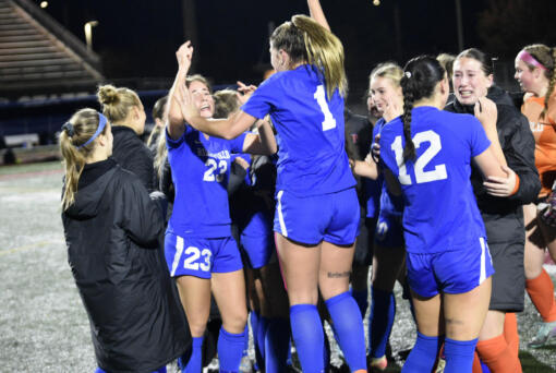 Ridgefield's Abigail Vance (23) and Nora Martin (1) jump in jubilation after defeating Columbia River 1-0 in the championship game on Saturday, Nov. 23, 2024, at Mount Tahoma High School.