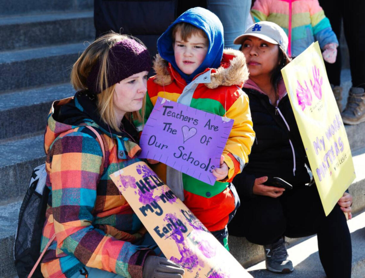 Child care workers, parents and children gather at the Idaho Capitol Building on March 8, 2023, to call attention to state budget cuts to child care provider funding. (Sarah A.