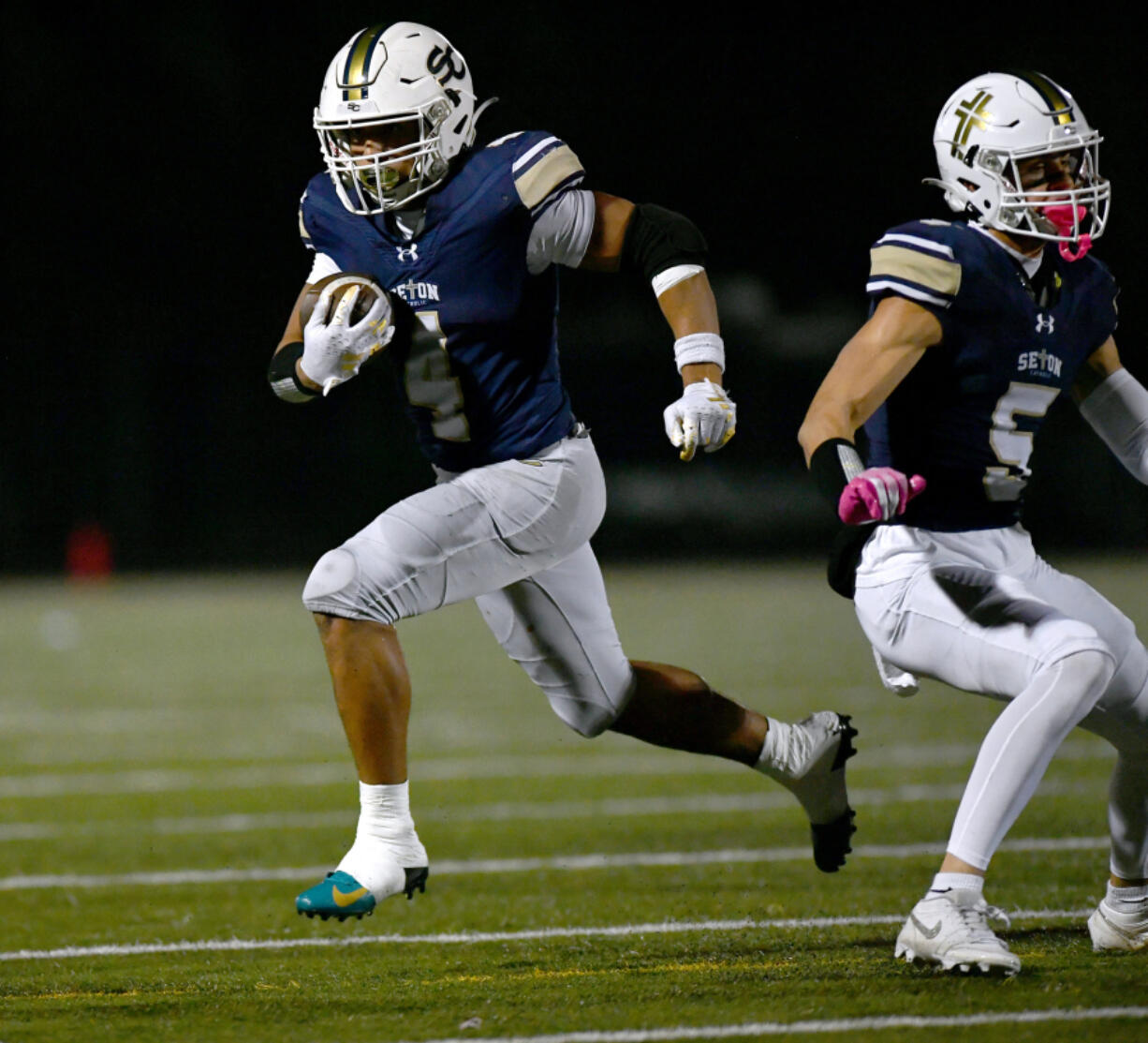 Seton Catholic senior Jacob Williams (4) runs the ball Saturday, Nov. 23, 2024, during the Cougars&iacute; 42-41 win against Life Christian Academy in the 1A State Football Playoff quarterfinals at Doc Harris Stadium in Camas.