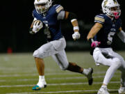 Seton Catholic senior Jacob Williams (4) runs the ball Saturday, Nov. 23, 2024, during the Cougars&iacute; 42-41 win against Life Christian Academy in the 1A State Football Playoff quarterfinals at Doc Harris Stadium in Camas.