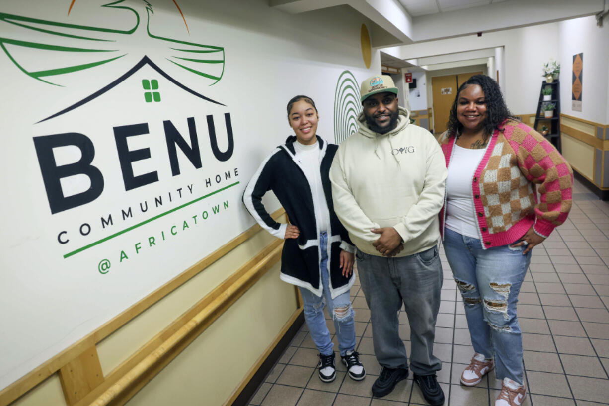 Program Assistant Ashv&copy; Ricketts, left, Advocate Dagmawi Haile-Leul, center, and Program Coordinator Clenna Brooks-Pope, right, pose for a portrait at Africatown&Ccedil;&fnof;&Ugrave;s Benu shelter for Black men in Seattle on Thursday, Nov. 7, 2024.