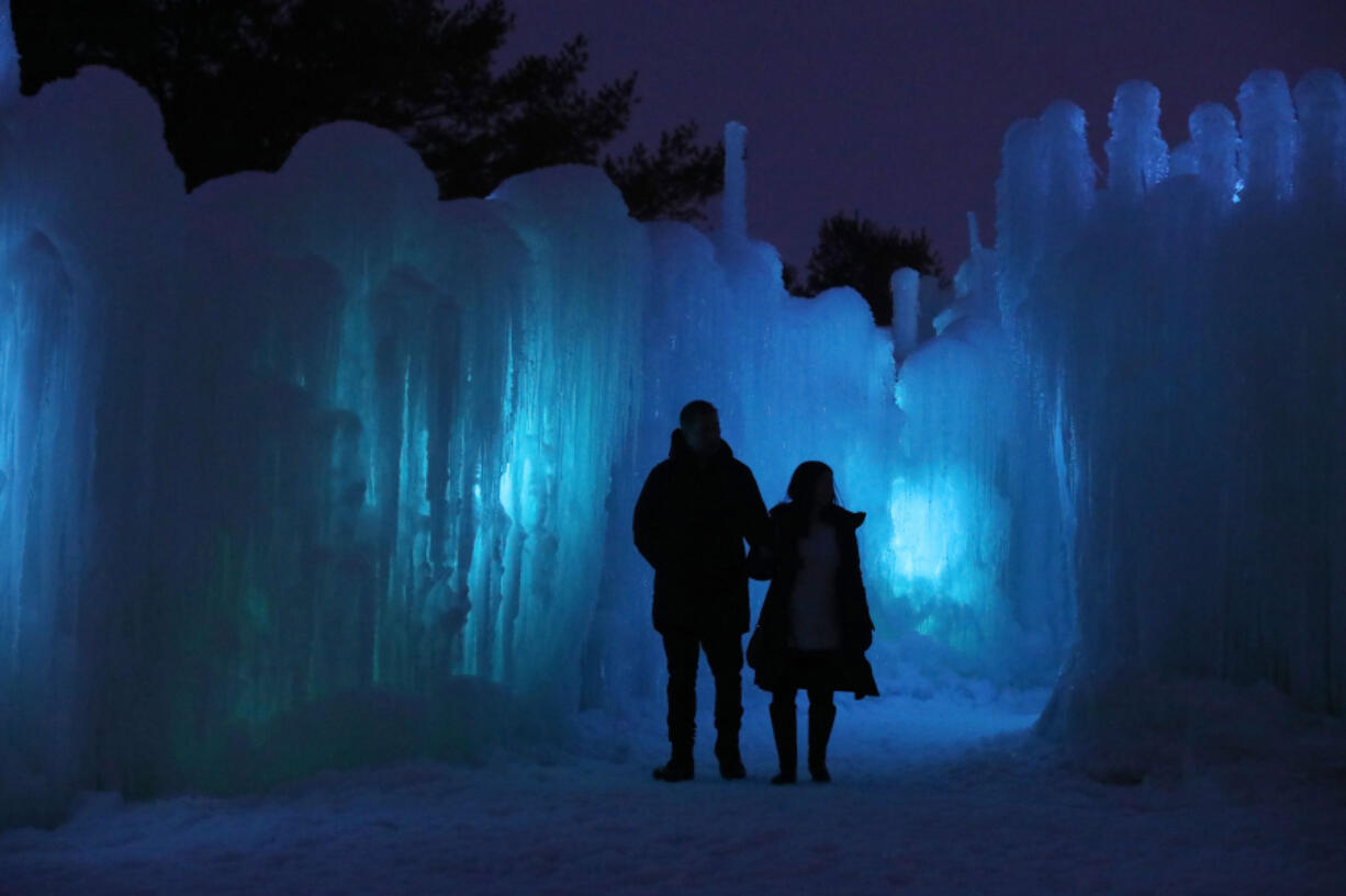 A couple enters Ice Castles in Lake Geneva, Wisc. Several Ice Castles displays are set up each year at various locations across the country.