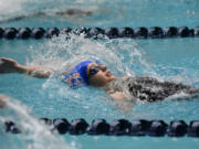 Medea Rusu of Ridgefield swims in the final of the 100-yard backstroke at the Class 2A girls swimming state championship meet at the King County Aquatic Center in Federal Way on Saturday, Nov. 16, 2024.