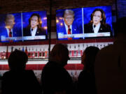 Viewers gather to watch a debate between Democratic presidential nominee Vice President Kamala Harris and Republican presidential nominee former President Donald Trump at the Angry Elephant Bar and Grill, Tuesday, Sept. 10, 2024, in San Antonio.