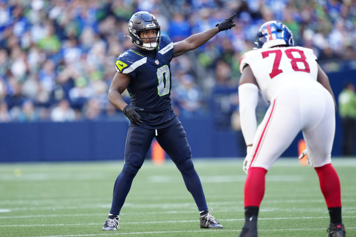 Seattle Seahawks linebacker Tyrel Dodson (0) points during an NFL football game against the New York Giants, Sunday, Oct. 6, 2024 in Seattle. The Giants won 29-20.