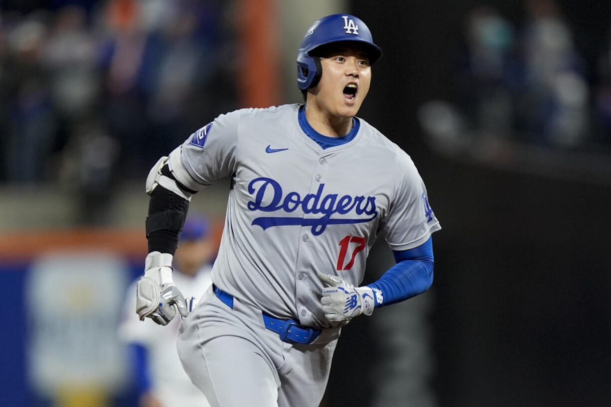 Los Angeles Dodgers' Shohei Ohtani celebrates after a home run against the New York Mets during the first inning in Game 4 of a baseball NL Championship Series, Thursday, Oct. 17, 2024, in New York.