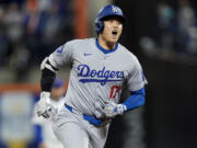 Los Angeles Dodgers' Shohei Ohtani celebrates after a home run against the New York Mets during the first inning in Game 4 of a baseball NL Championship Series, Thursday, Oct. 17, 2024, in New York.