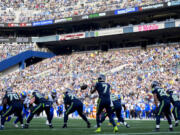 Seattle Seahawks quarterback Geno Smith (7) receives a snap against the Los Angeles Rams during an NFL football game, Sunday, Nov. 3, 2024, in Seattle.