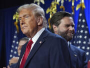 Republican presidential nominee former President Donald Trump and his running mate Sen. JD Vance, R-Ohio, stand on stage at an election night watch party at the Palm Beach Convention Center, Wednesday, Nov. 6, 2024, in West Palm Beach, Fla.