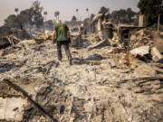 Marvin Meador walks on the remains of his fire-ravaged property after the Mountain Fire swept through, Thursday, Nov. 7, 2024, in Camarillo, Calif.