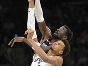 San Antonio Spurs' Victor Wembanyama (1) and Portland Trail Blazers' Deandre Ayton reach for the jump ball at the start of an NBA basketball game, Thursday, Nov. 7, 2024, in San Antonio.