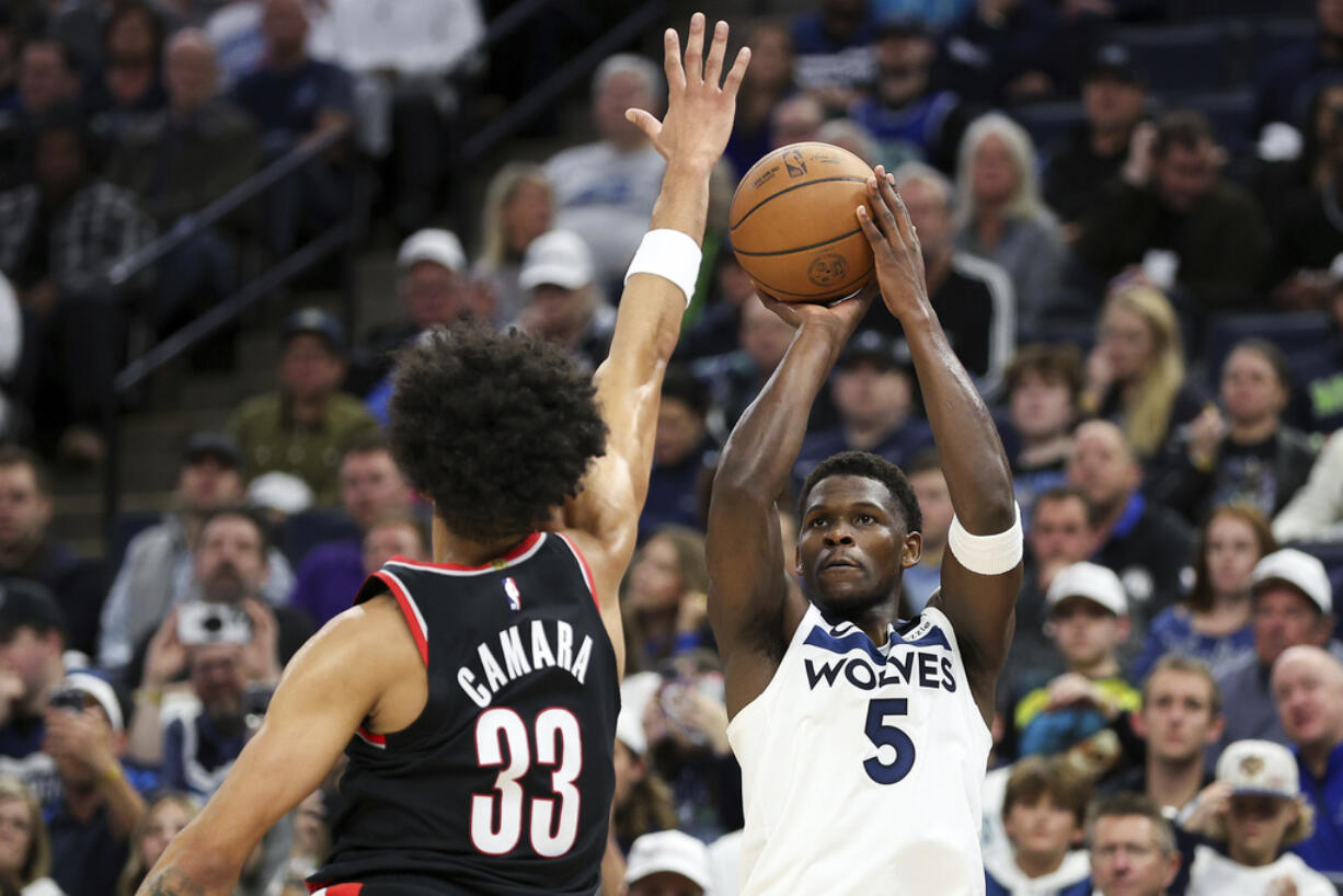 Minnesota Timberwolves guard Anthony Edwards (5) shoots as Portland Trail Blazers forward Toumani Camara (33) defends during the second half of an NBA basketball game, Friday, Nov. 8, 2024, in Minneapolis.