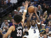 Minnesota Timberwolves guard Anthony Edwards (5) shoots as Portland Trail Blazers forward Toumani Camara (33) defends during the second half of an NBA basketball game, Friday, Nov. 8, 2024, in Minneapolis.