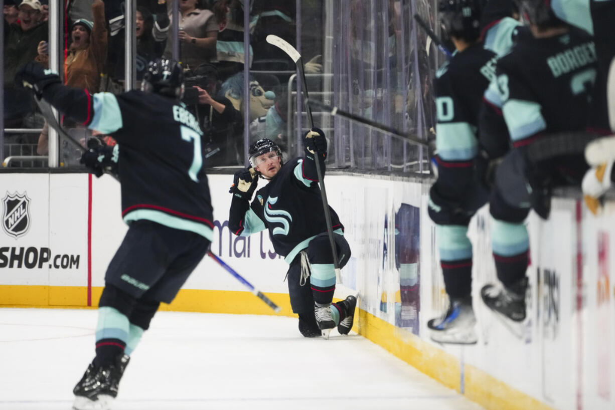 Seattle Kraken left wing Jared McCann, center, reacts to scoring the game-winning goal during overtime for win over the Vegas Golden Knights in an NHL hockey game Friday, Nov. 8, 2024, in Seattle.