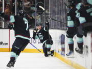 Seattle Kraken left wing Jared McCann, center, reacts to scoring the game-winning goal during overtime for win over the Vegas Golden Knights in an NHL hockey game Friday, Nov. 8, 2024, in Seattle.