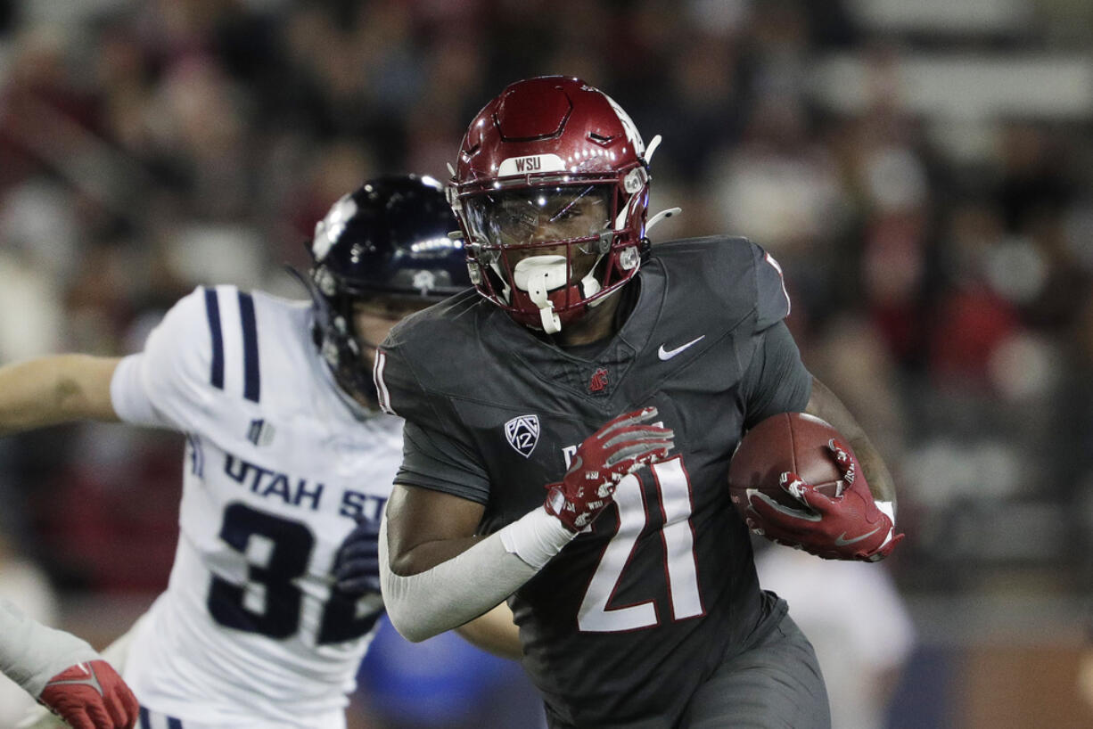 Washington State running back Wayshawn Parker (21) carries the ball during the first half of an NCAA college football game against Utah State, Saturday, Nov. 9, 2024, in Pullman, Wash.