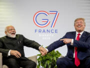 FILE- President Donald Trump and Indian Prime Minister Narendra Modi, left, share a laugh together during a bilateral meeting at the G-7 summit in Biarritz, France, Aug. 26, 2019.