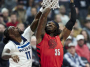 Portland Trail Blazers center Robert Williams III, right, shoots over Minnesota Timberwolves center Naz Reid during the first half of an Emirates NBA Cup basketball game in Portland, Ore., Tuesday, Nov. 12, 2024.