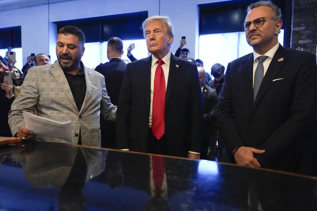 FILE - Republican presidential nominee former President Donald Trump, center, listens to Albert Abbas, owner of The Great Commoner, left, as Massad Boulos looks on during a visit to the cafe, Nov. 1, 2024, in Dearborn, Mich.