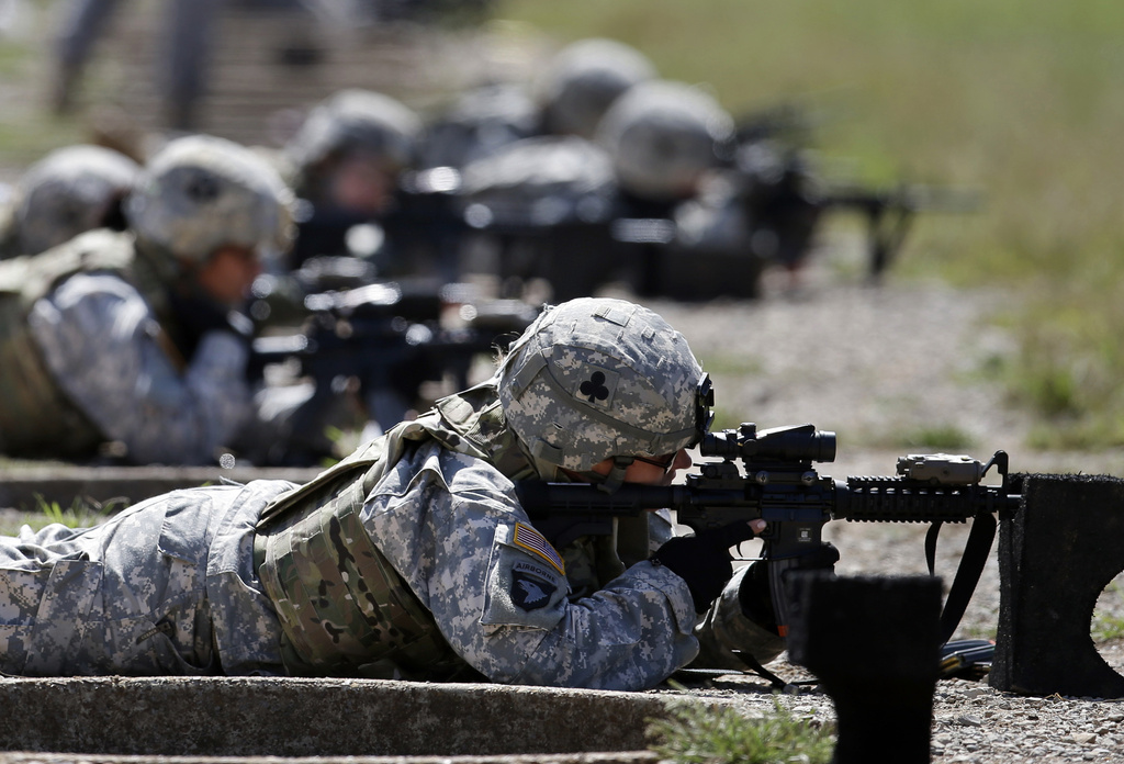 FILE - Female soldiers from 1st Brigade Combat Team, 101st Airborne Division train on a firing range while testing new body armor in Fort Campbell, Ky., Sept. 18, 2012.