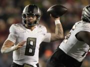 Oregon's Dillon Gabriel (8) thorws a pass during the first half of an NCAA college football game against Wisconsin Saturday, Nov. 16, 2024, in Madison, Wis.