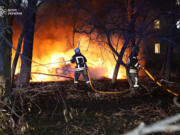 In this photo provided by the Ukrainian Emergency Service, firefighters extinguish the fire following a Russian rocket attack that hit a multi-storey apartment building in Sumy, Ukraine, Sunday, Nov. 17, 2024.