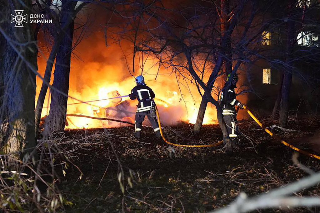 In this photo provided by the Ukrainian Emergency Service, firefighters extinguish the fire following a Russian rocket attack that hit a multi-storey apartment building in Sumy, Ukraine, Sunday, Nov. 17, 2024.