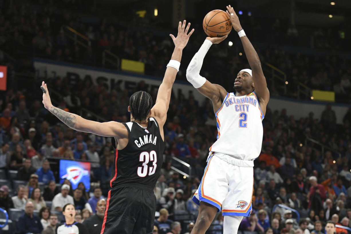 Oklahoma CIty Thunder guard Shai Gilgeous-Alexander (2) shoots over Portland Trail Blazers forward Toumani Camara (33) during the second half of an NBA basketball game, Wednesday, Nov. 20, 2024, in Oklahoma City.