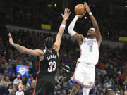 Oklahoma CIty Thunder guard Shai Gilgeous-Alexander (2) shoots over Portland Trail Blazers forward Toumani Camara (33) during the second half of an NBA basketball game, Wednesday, Nov. 20, 2024, in Oklahoma City.