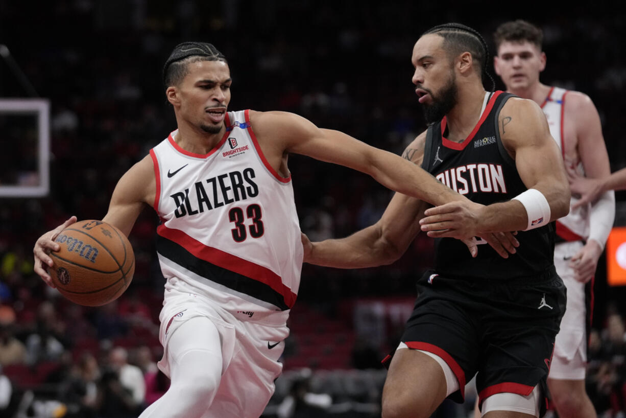 Houston Rockets forward Dillon Brooks, right, defends against Portland Trail Blazers forward Toumani Camara (33) during the first half of an Emirates NBA Cup basketball game in Houston, Friday, Nov. 22, 2024.