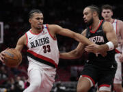 Houston Rockets forward Dillon Brooks, right, defends against Portland Trail Blazers forward Toumani Camara (33) during the first half of an Emirates NBA Cup basketball game in Houston, Friday, Nov. 22, 2024.