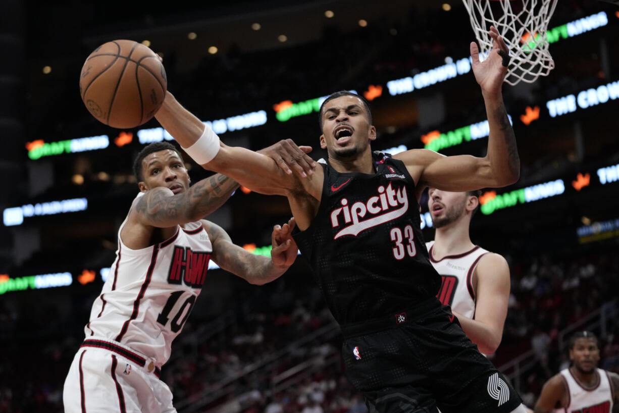 Houston Rockets forward Jabari Smith Jr. (10) defends against Portland Trail Blazers forward Toumani Camara (33) during the first half of an NBA basketball game in Houston, Saturday, Nov. 23, 2024.