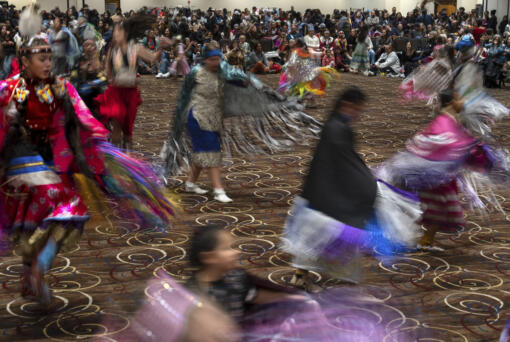 People dance in a powwow at Chinook Winds Casino Resort, Saturday, Nov. 16, 2024, in Lincoln City, Ore.