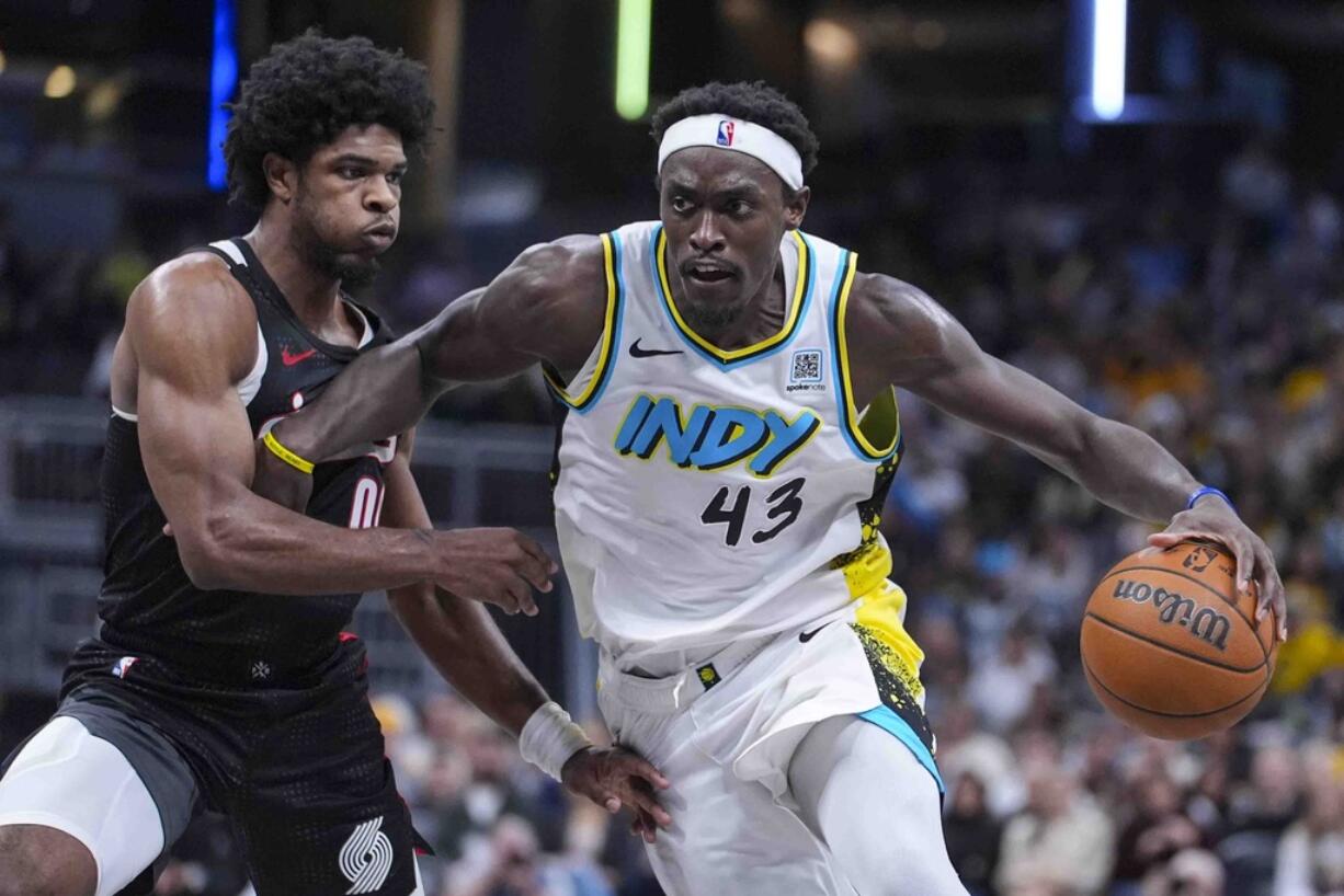 Indiana Pacers forward Pascal Siakam (43) drives past Portland Trail Blazers guard Scoot Henderson (00) during the second half of an NBA basketball game in Indianapolis, Wednesday, Nov. 27, 2024.