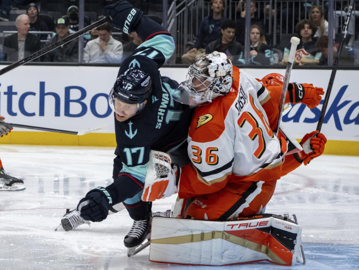 Seattle Kraken forward Jaden Schwartz, left, collides with Anaheim Ducks goalie John Gibson during the second period of an NHL hockey game, Wednesday, Nov. 27, 2024, in Seattle.