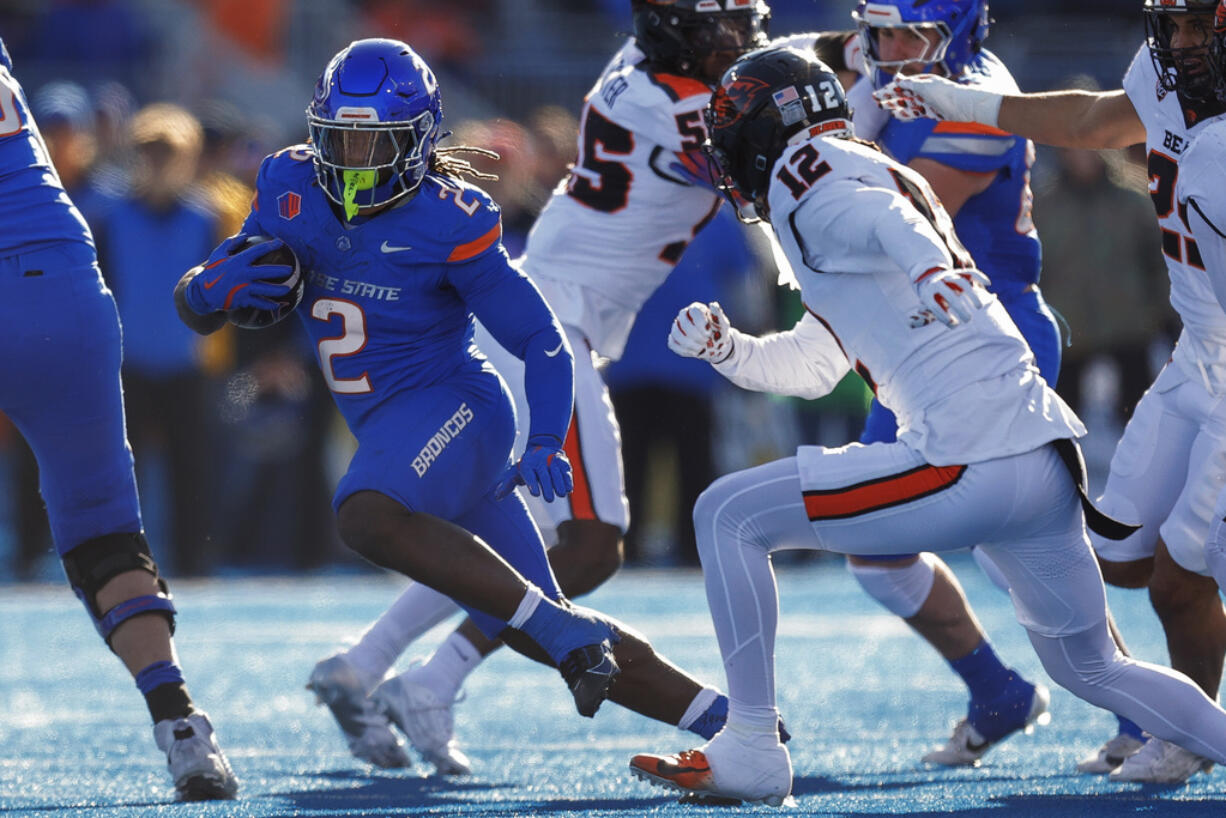 Boise State running back Ashton Jeanty (2) cuts away from Oregon State defensive back Tyrice Ivy Jr. (12) on a run in the first half of an NCAA college football game, Friday, Nov. 29, 2024, in Boise, Idaho.