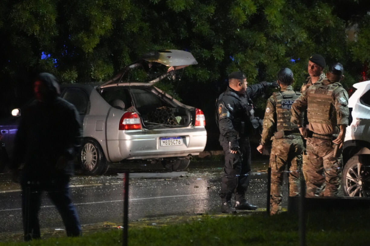 Police inspect a vehicle outside the Supreme Court in Bras&iacute;lia, Brazil, following an explosion, Wednesday, Nov. 13, 2024.