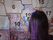 A voter colors the state of Illinois blue during an election night watch party, Tuesday, Nov. 5, 2024, in Cincinnati.