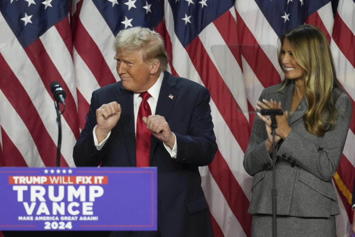 Republican Presidential nominee former President Donald Trump dances as former first lady Melania Trump watches at the Palm Beach County Convention Center during an election night watch party, Wednesday, Nov. 6, 2024, in West Palm Beach, Fla.