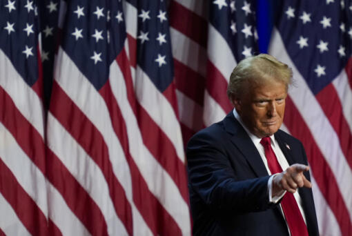 Republican presidential nominee former President Donald Trump points to the crowd at an election night watch party, Wednesday, Nov. 6, 2024, in West Palm Beach, Fla.