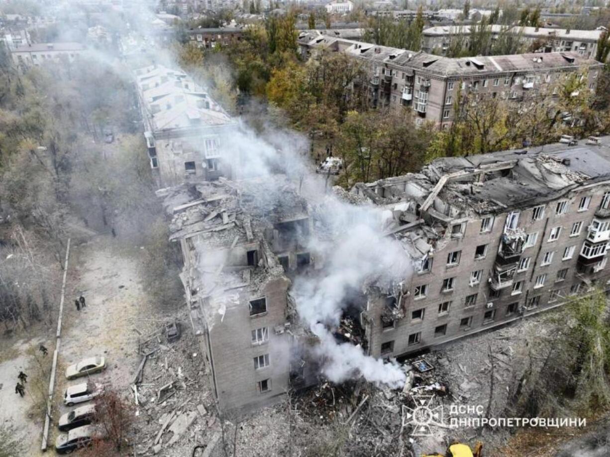 In this image provided by the Ukrainian Emergency Service on Monday, Nov. 11, 2024, a smoke rises out of an apartments building after a Russian attack in Kryvyi Rih, Ukraine.