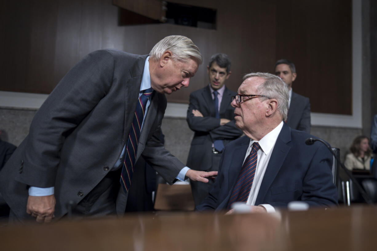 Senate Judiciary Committee Chairman Dick Durbin, D-Ill., seated at right, confers with Sen. Lindsey Graham, R-S.C., left, the ranking member, as the panel convenes to confirm President Joe Biden&rsquo;s nominees in the closing weeks of the 118th Congress and before Donald Trump takes office, at the Capitol in Washington, Thursday, Nov. 14, 2024. (AP Photo/J.