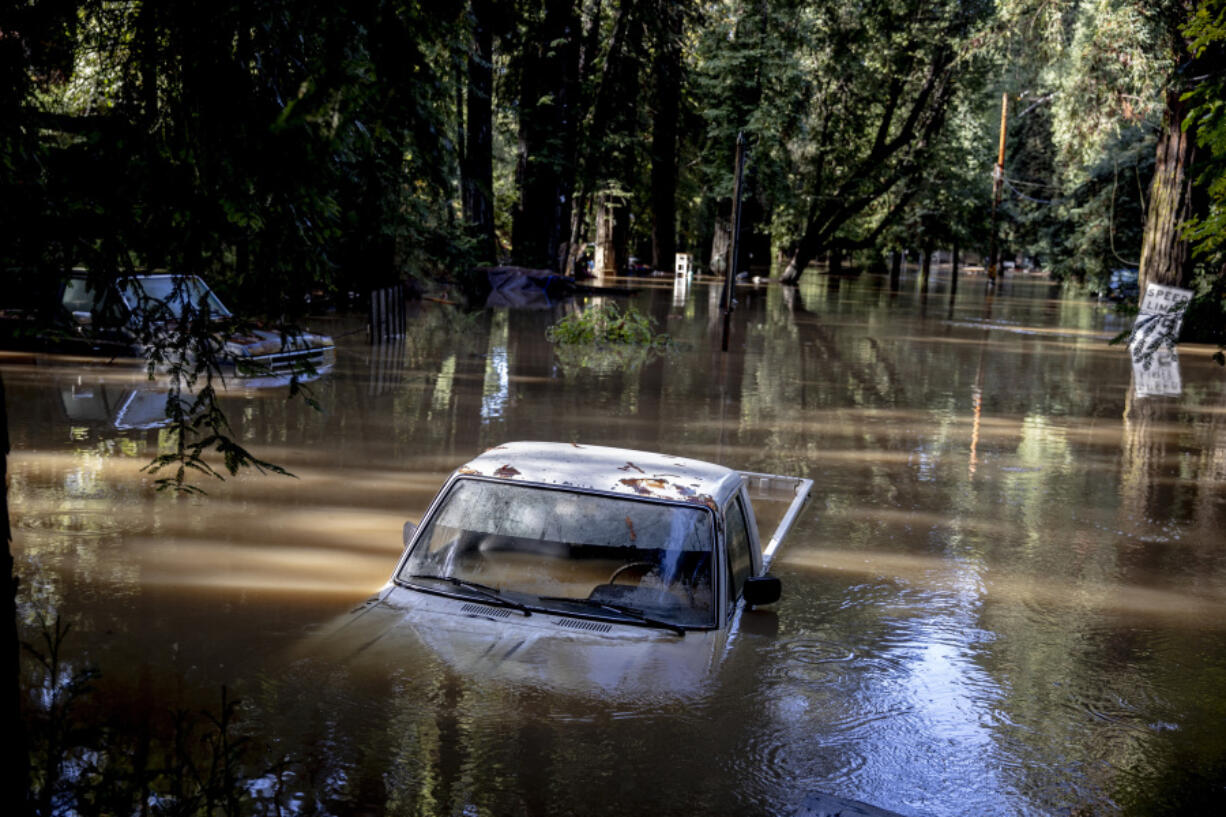 A car is submerged in floodwaters Saturday at Mirabel RV Park &amp; Campground in Forestville, Calif.