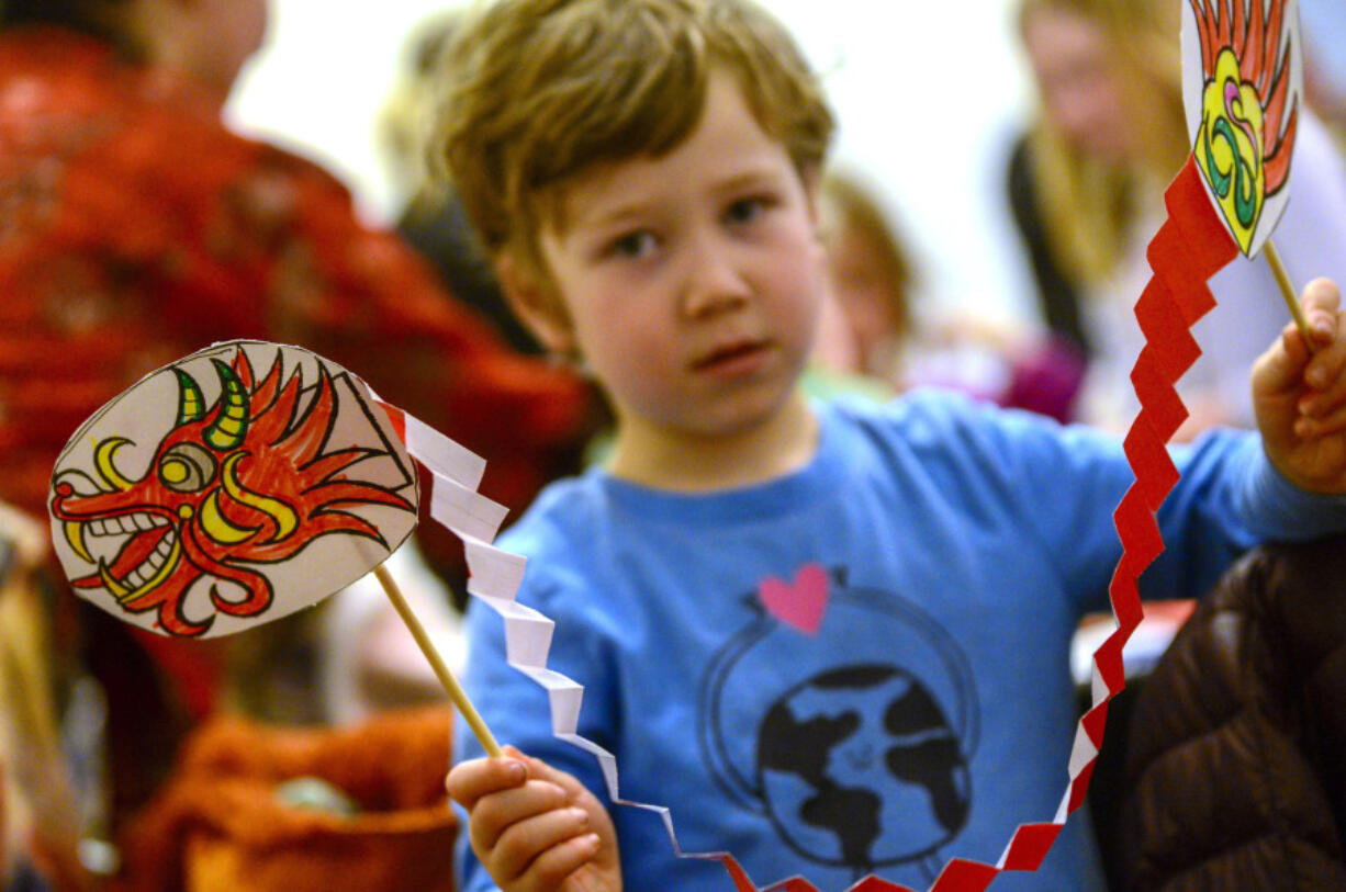 FILE - Bennett Morse, 5, of Guilford, Vt., shows off a dragon he made during the Asian Cultural Center of Vermont&rsquo;s annual Lunar New Year Festival at the Brattleboro Museum and Arts Center in Brattleboro, Vt., Feb. 10, 2024.