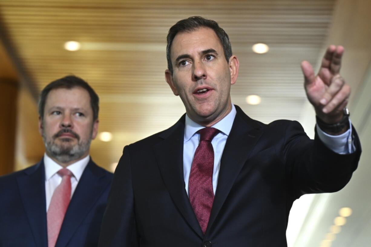 Australian Treasurer Jim Chalmers, right, gestures as he and Industry Minister Ed Husic speak to the media during a press conference at Parliament House in Canberra, Friday, Nov. 22, 2024.